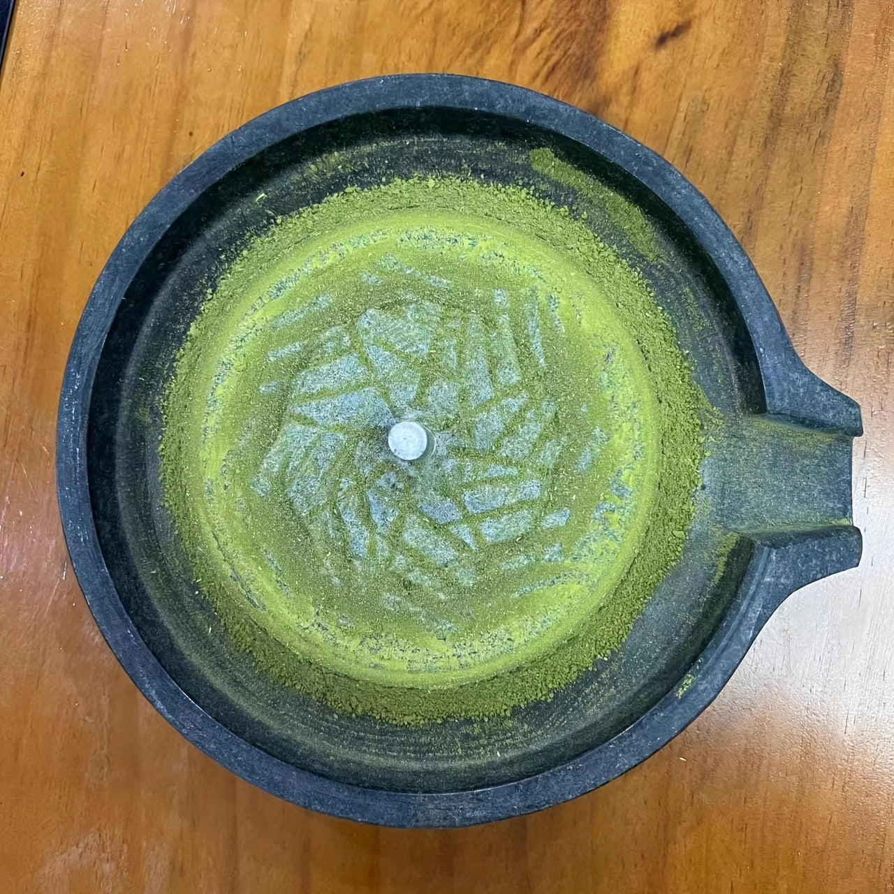 Handcrafted bluestone grinder for tea, coffee, and pepper, along with a matching handmade tea set and stone grinder for matcha. A perfect addition to any household's collection of tea grinding utensils, complete with beautiful graphite ornaments.