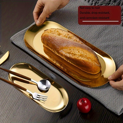 Golden-finish stainless steel oval tray - Minimalist design, durable and easy to clean. Ideal for serving bread, desserts, and snacks in stylish table settings.