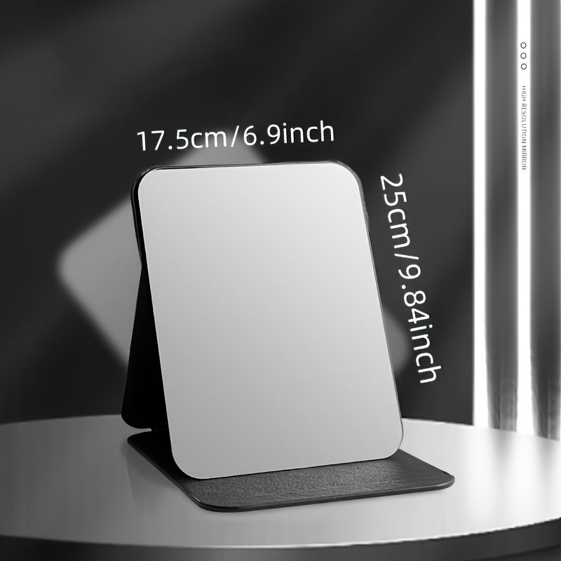 Stylish black foldable makeup mirror, great for desk, bedroom, and bathroom decor. Ideal for travel and makes a unique gift for weddings, parties, and birthdays. Glass surface with polished finish.