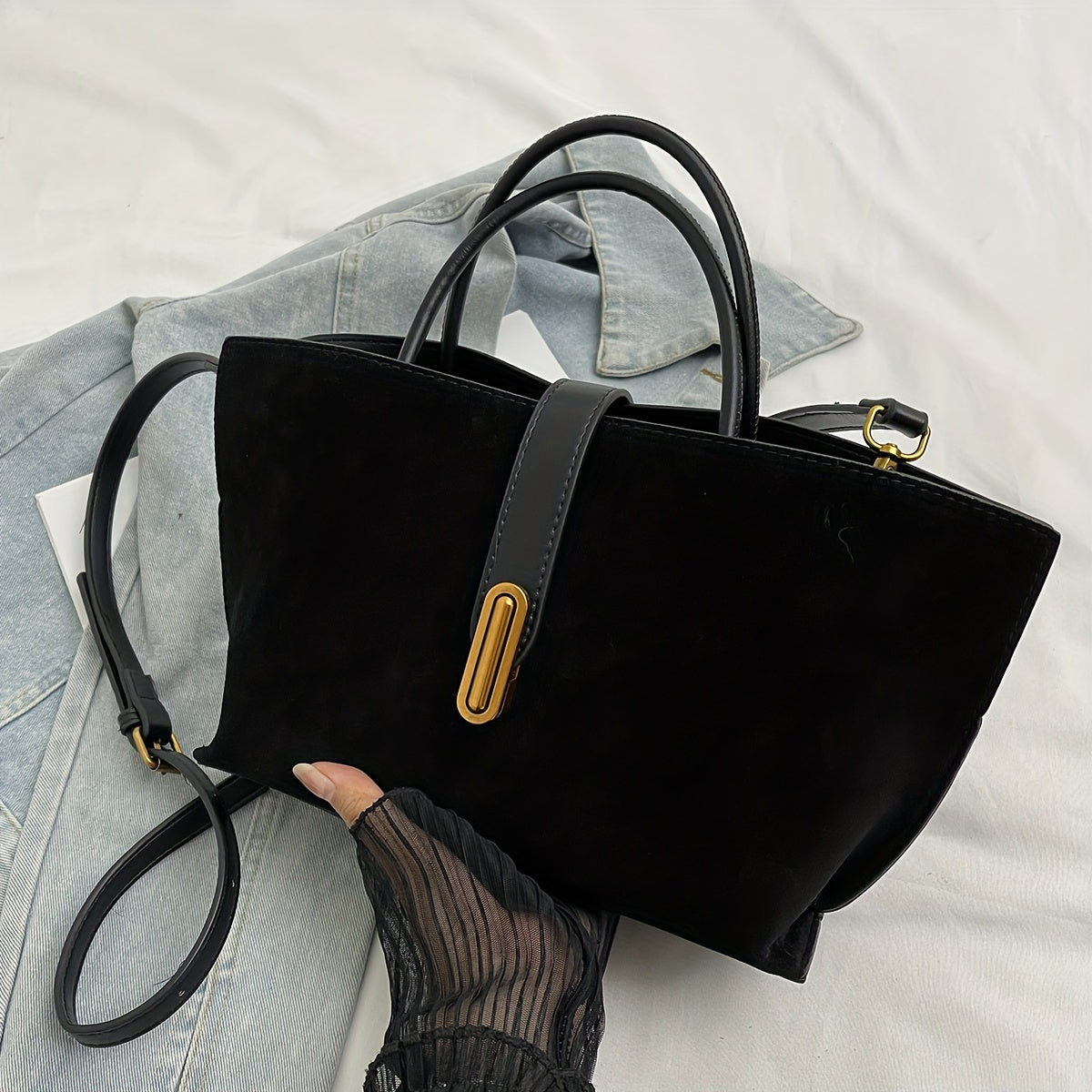 Adjustable shoulder strap tote bag with vintage style and retro large capacity, made from suede leather. Features turn lock closure and unlined fabric material.