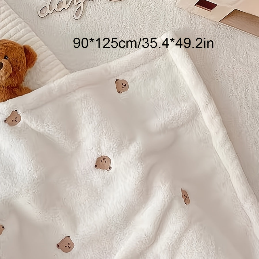 Soft polyester white blanket featuring an embroidered bear design, perfect for cozy youngsters.