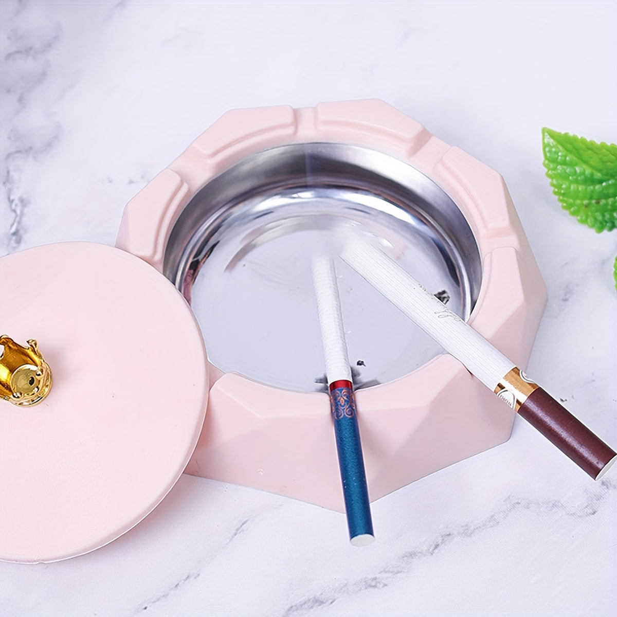 Plastic ashtray with rotating lid for outdoor and indoor smoking.