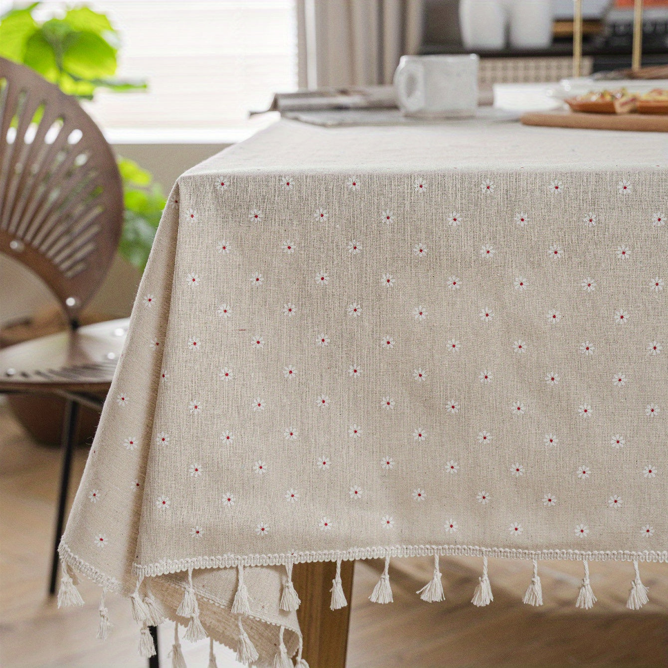 White chrysanthemum and beige linen print farmhouse floral tablecloth with tassels, ideal for kitchen and dining decor. Ready for Thanksgiving, made of polyester, rectangular shape.