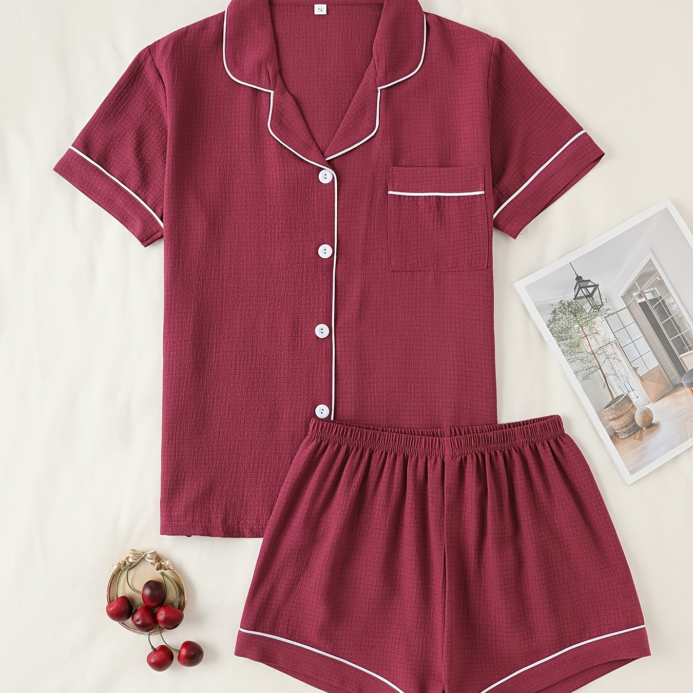 Basic pajama set for women, featuring a short-sleeve button-up top with lapel collar and elastic shorts.