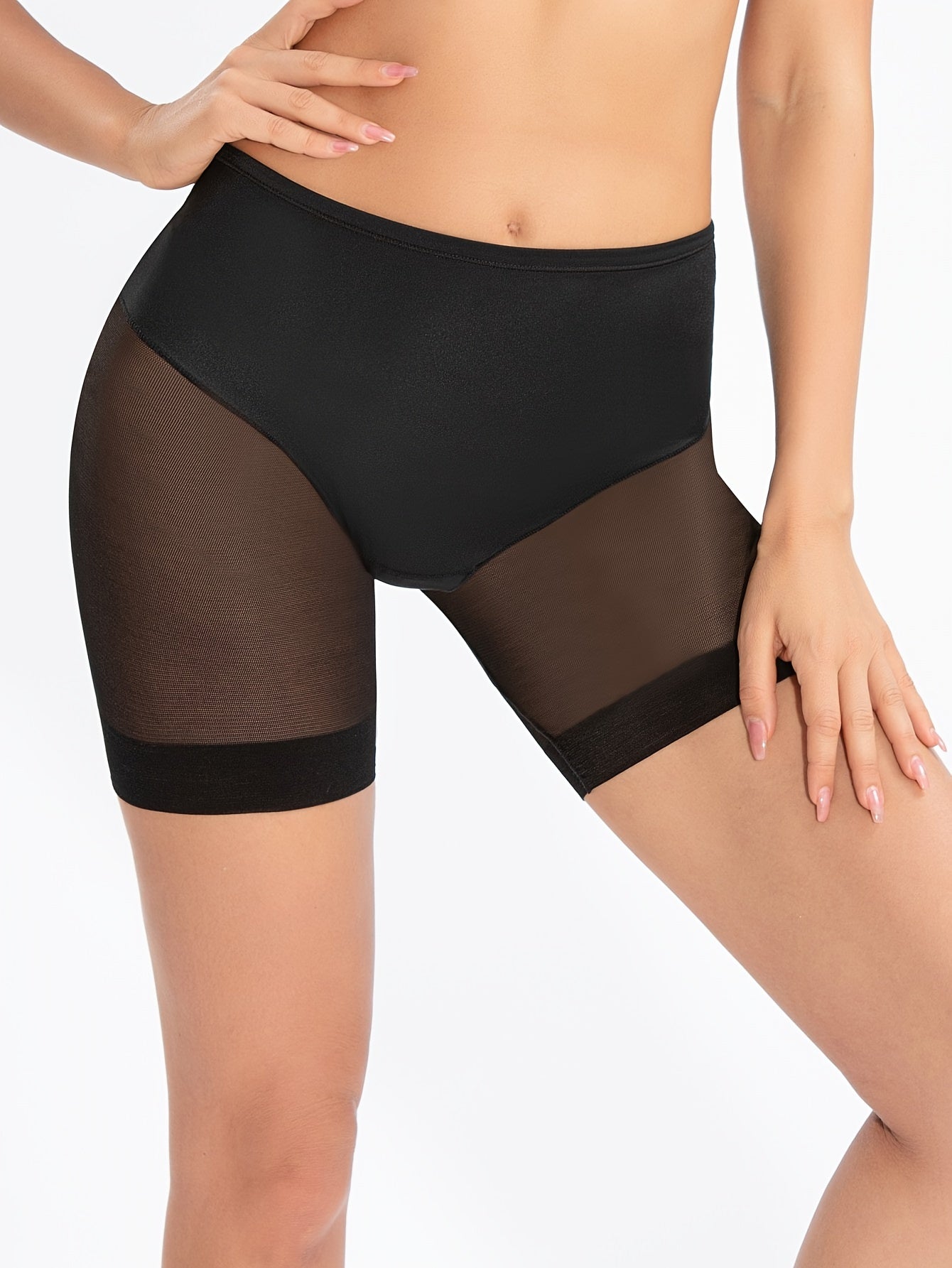 Mid-waist shaping shorts for women with mesh detailing to shape the body, cinch the waist, and flatten the stomach, featuring a lightweight design with flat legs.