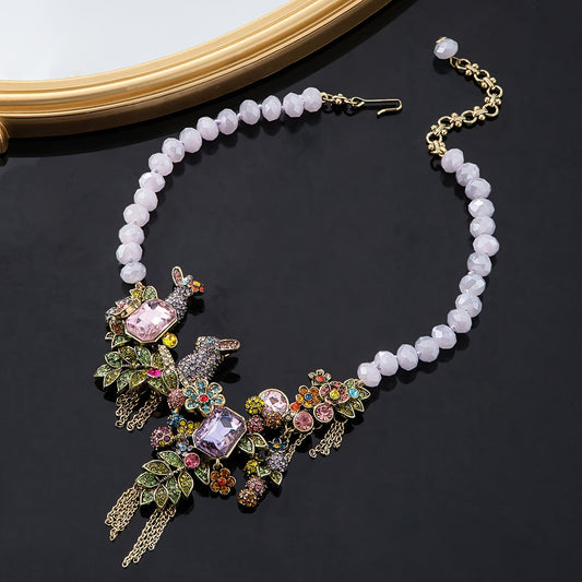 Necklace featuring an ornate vintage-style rabbit pendant with rhinestone tassels, glass crystals, and leaf accents.