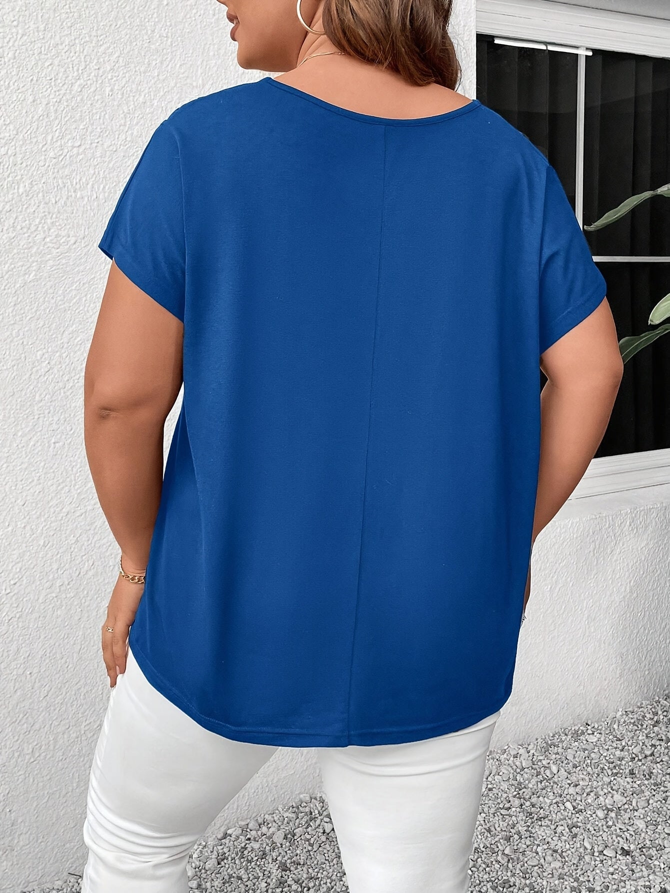 Stylish plus-size women's top with V-neck and crisscross detail, made of medium-stretch fabric, suitable for all seasons.