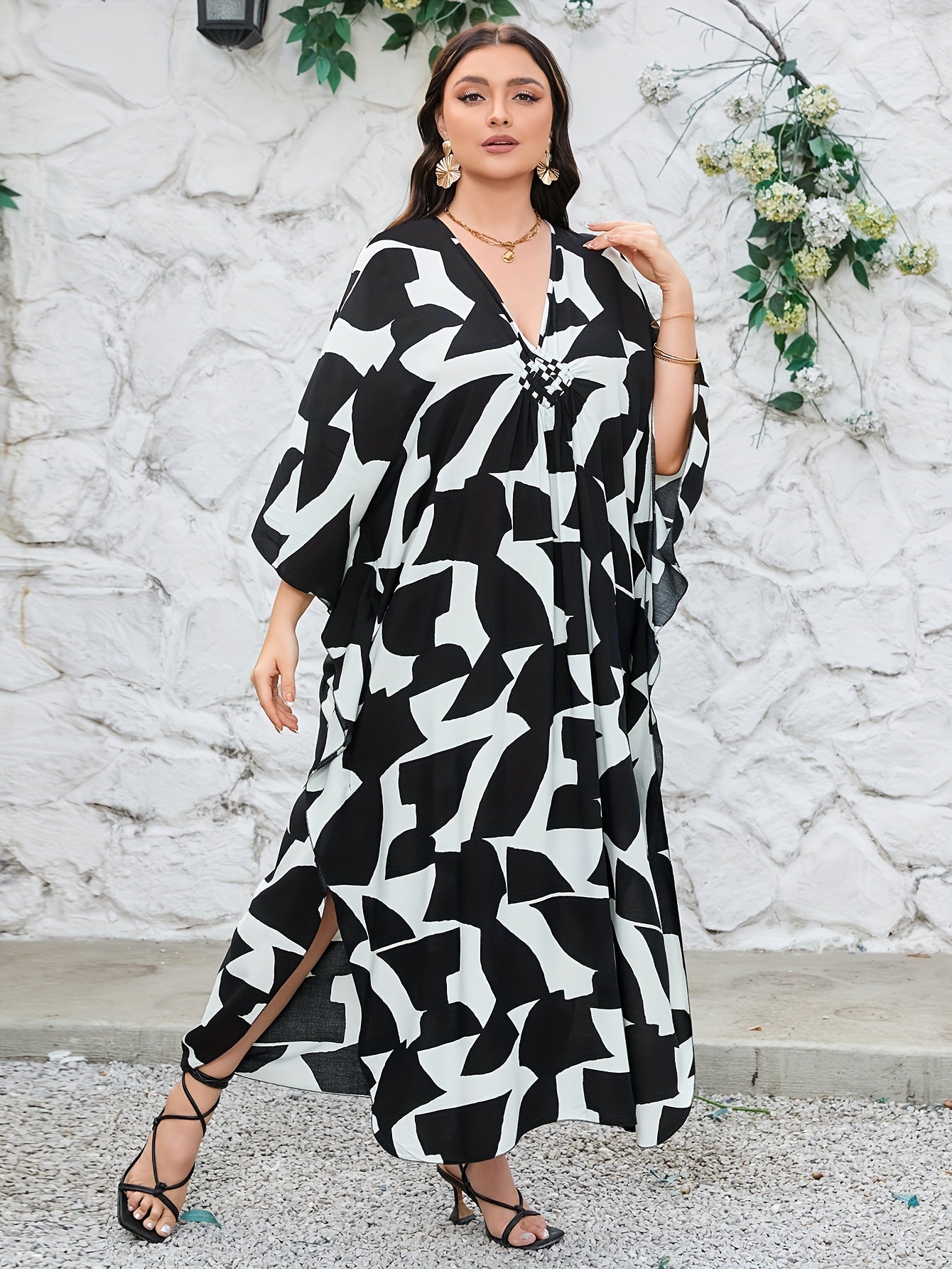 Boho-chic handwoven viscose beach kaftan dress in plus size, featuring a v-neck, 3/4 sleeves, a geometric black & white pattern, and machine washable. Great for vacation.