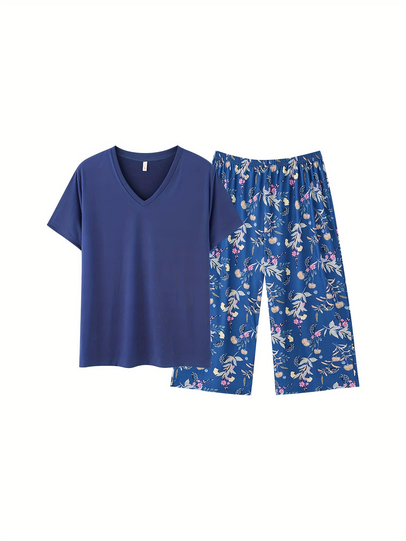 Plus size women's lounge set featuring a solid V-neck top and floral capri pants.