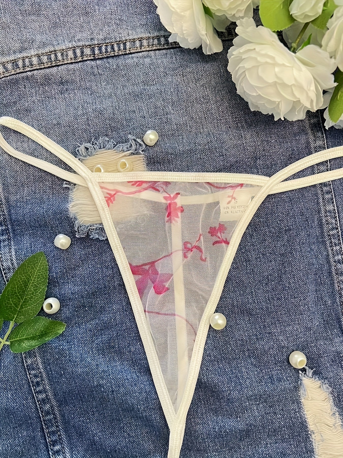 Floral print sheer thong panties made of breathable polyester and elastane blend, mid-rise and hand washable.