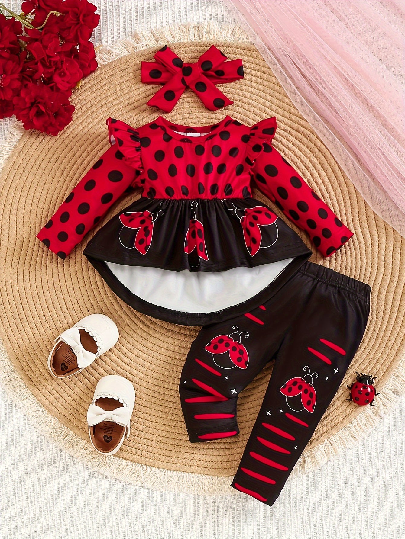 Ladybug print polyester toddler outfit with long sleeve crew neck pullover, matching pants, and headband. Made from slight stretch knit fabric for fall/winter. Regular fit raglan sleeve