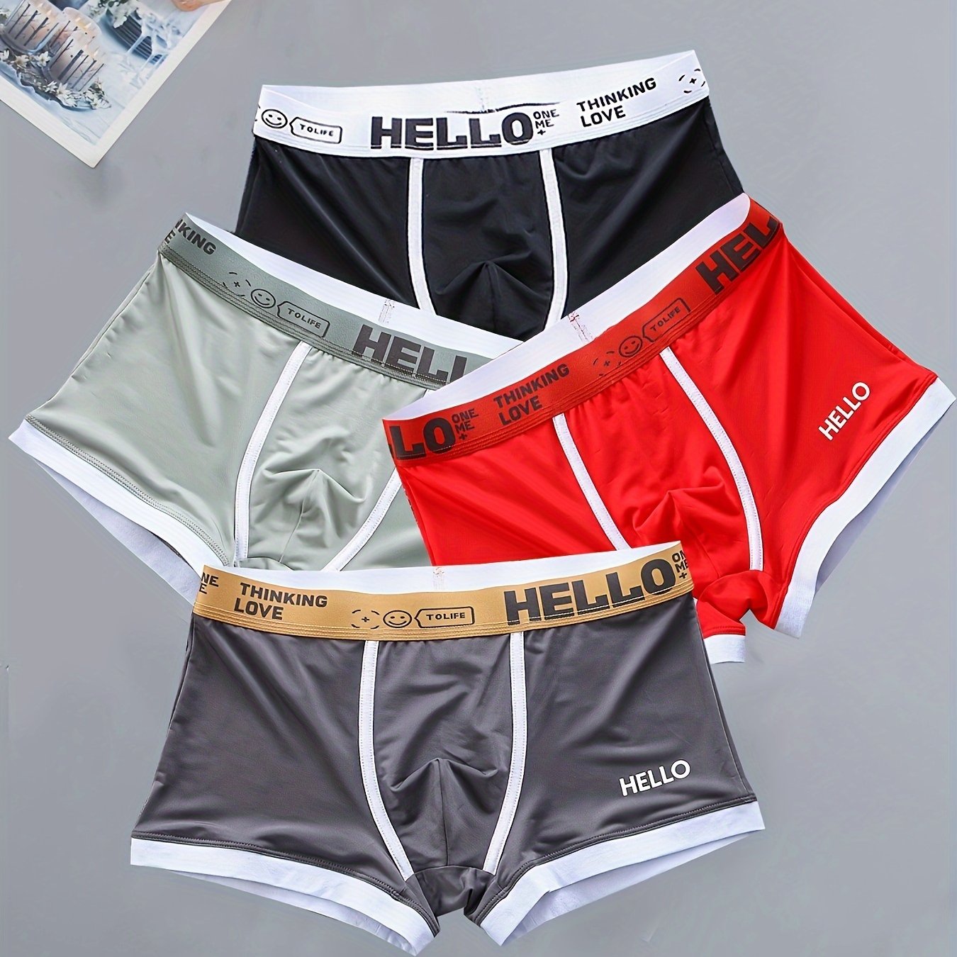 4 men's boxer briefs made with soft, breathable polyamide and elastane fabric featuring an alphabet pattern.