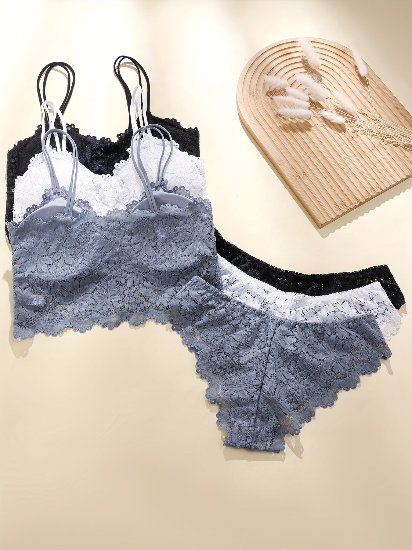 Sexy lingerie set includes cami bra and panties with solid floral lace for women.