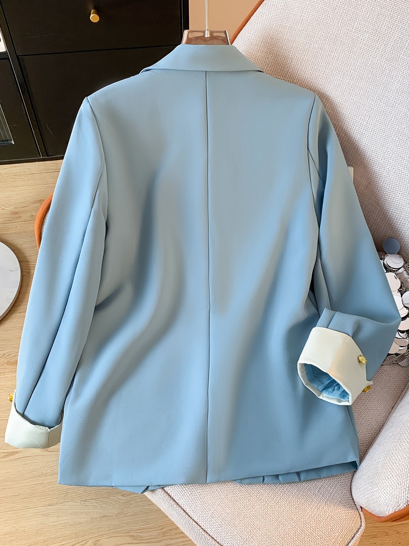 Stylish light blue blazer with golden button details for women, ideal for work in spring and fall.