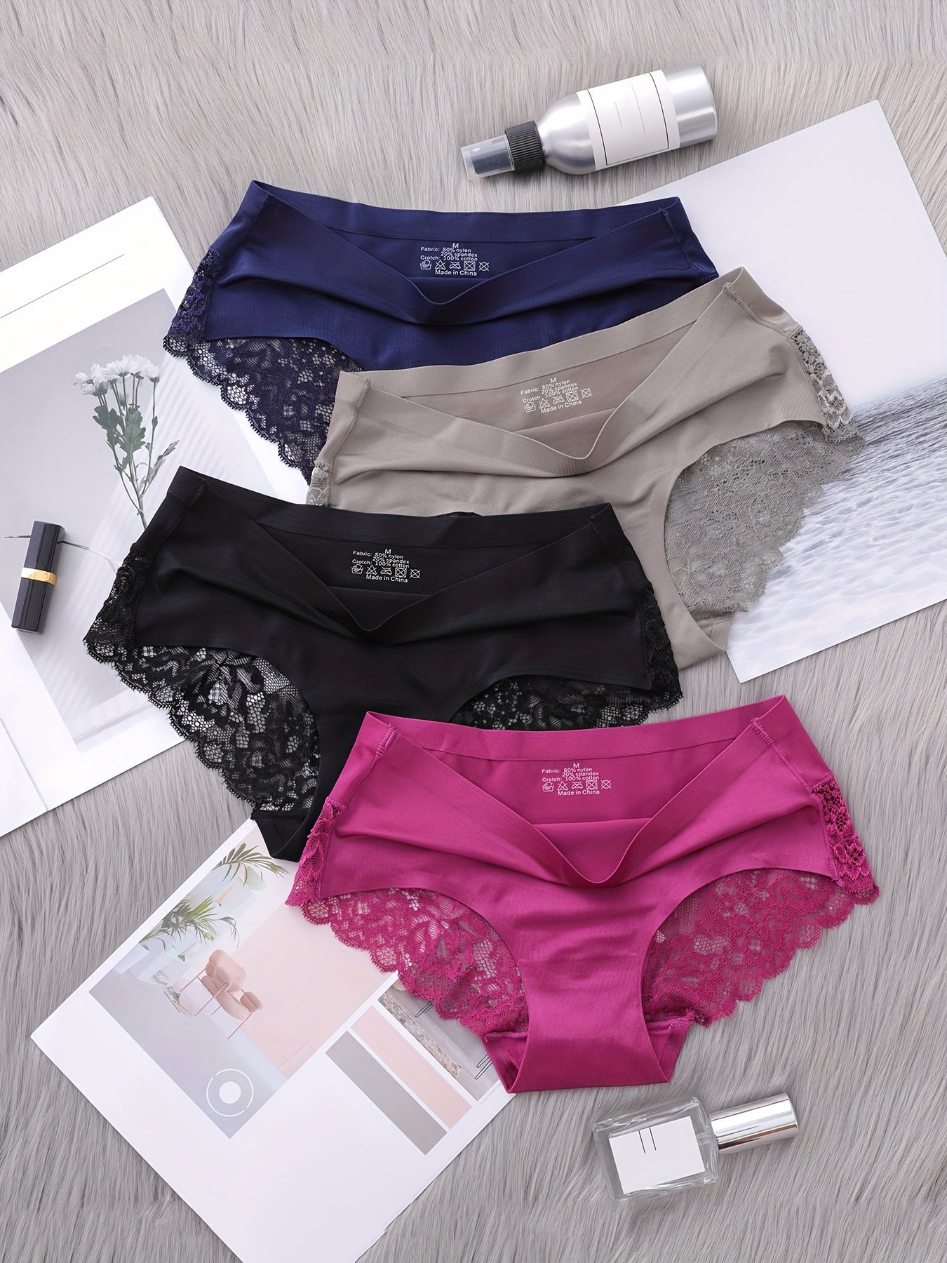 Set of 4 nylon knit fabric mid rise panties for women with solid color and lace details.