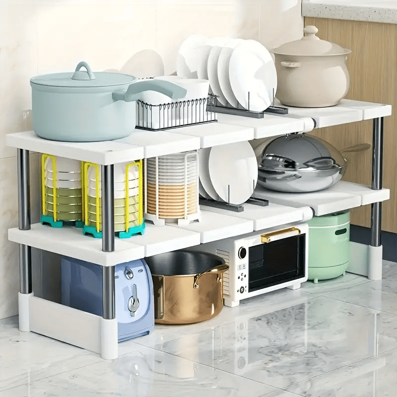 Adjustable plastic under sink organizer shelf with open storage rack for kitchen cabinet. No assembly needed, space-saving solution.