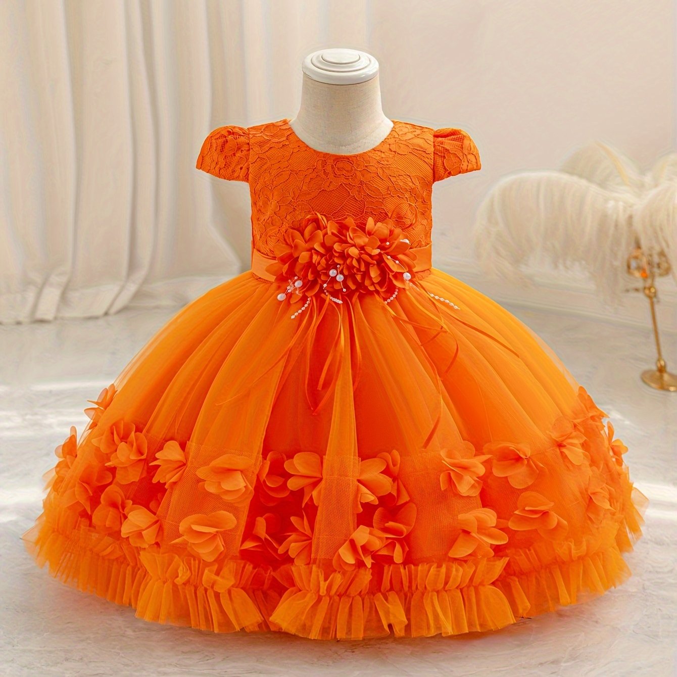 Baby's floral tulle princess dress with lace sleeves for formal occasions.