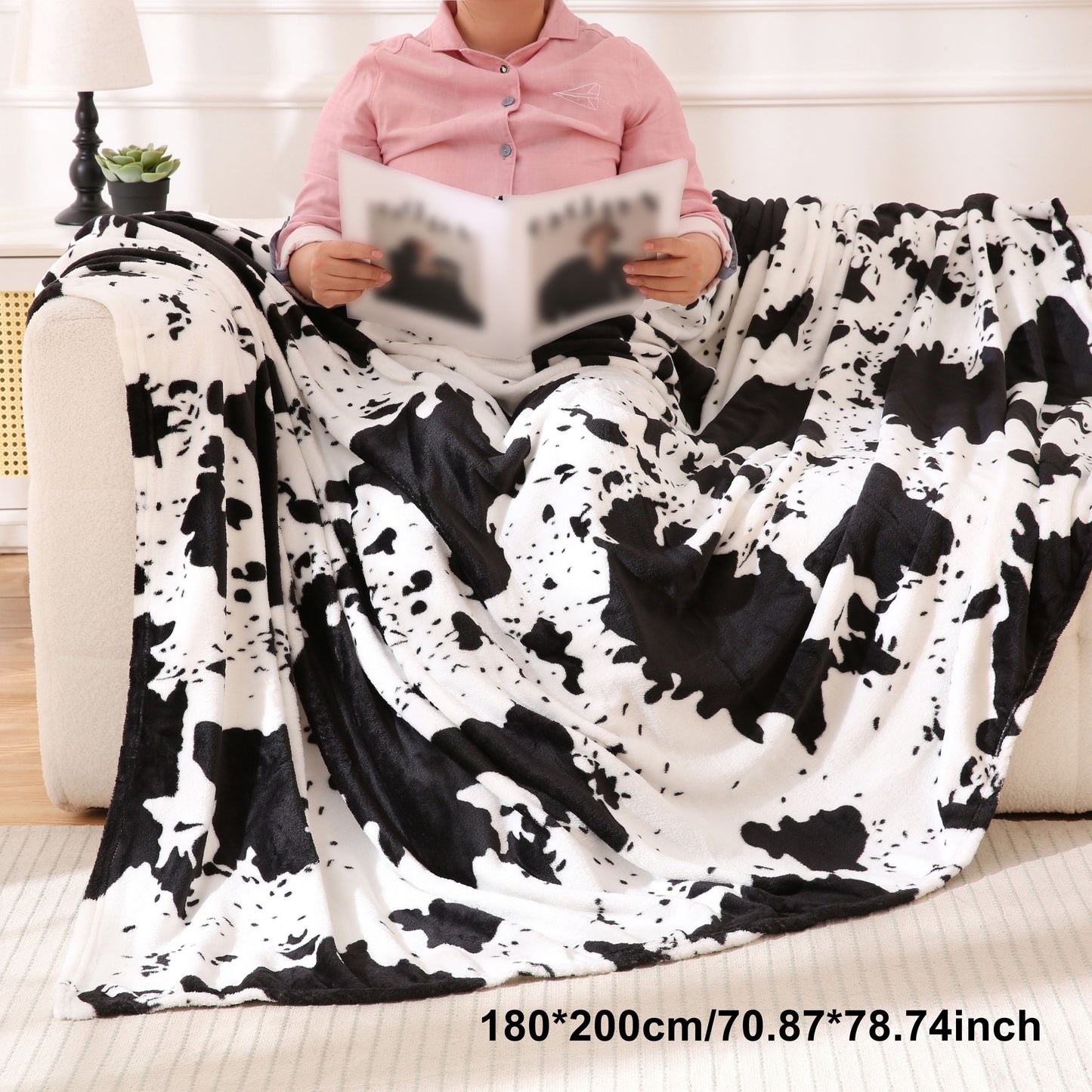 Get cozy with this soft and warm cow print blanket. Perfect for adding a touch of whimsy to your sofa, couch, or bed, this lightweight throw is made from plush flannel fleece. It's a great gift idea for any cow lover and perfect for all seasons.