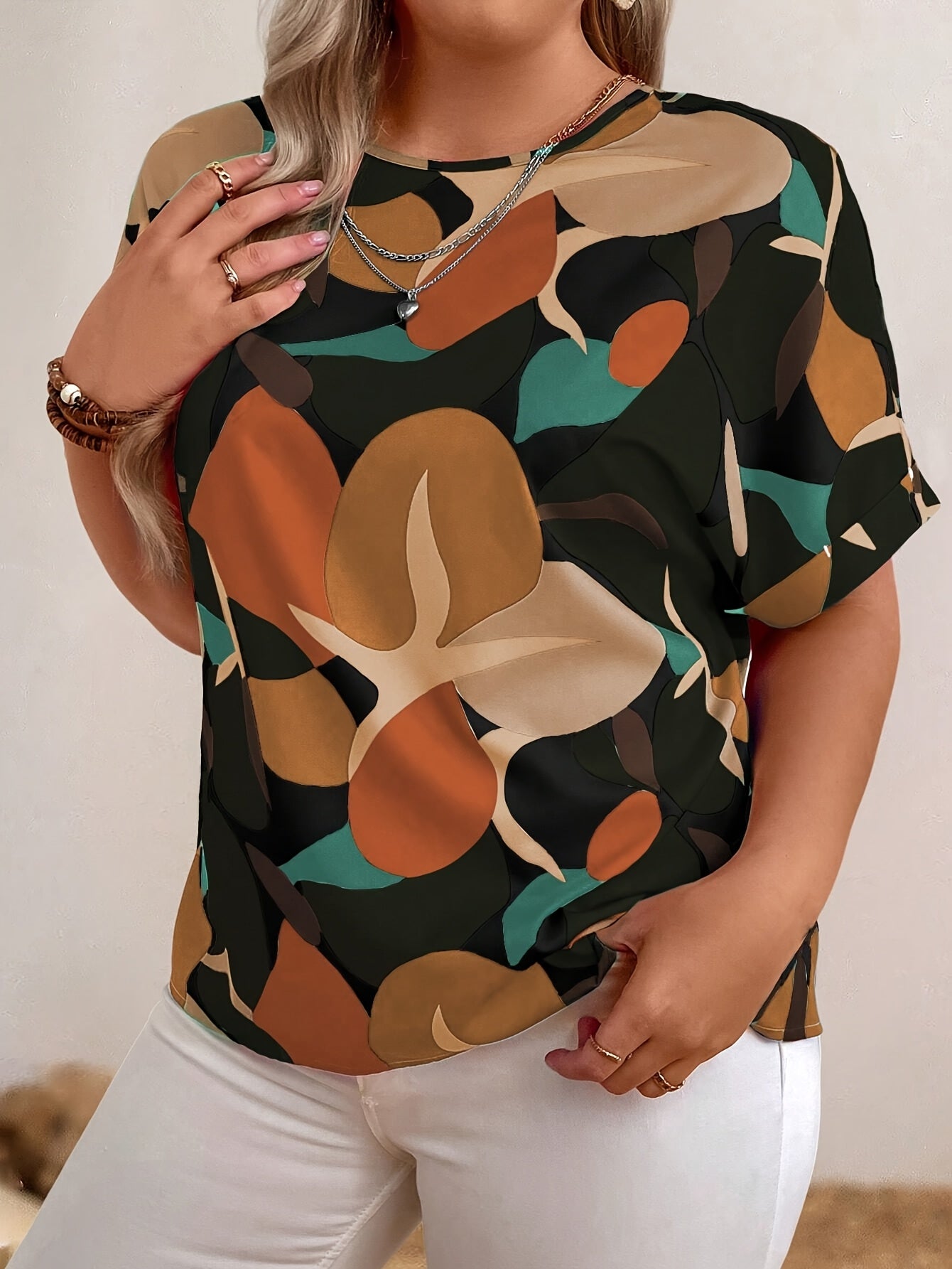 Plus size floral print batwing sleeve blouse in orange, brown & green camouflage design for women. Casual crew neck summer top.