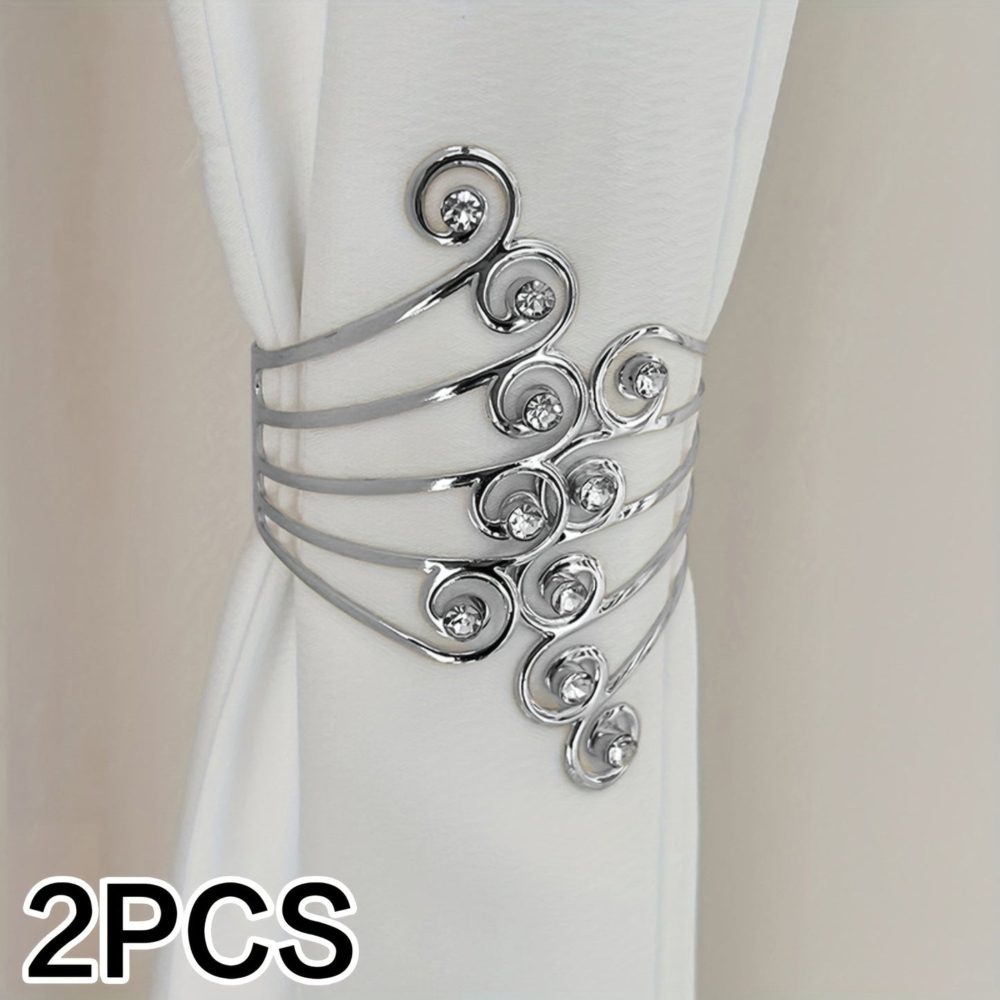 Add a touch of elegance to your home decor with these stunning Luxury Metal Gold/Silvery Creative Wings and Rhinestones Design Curtain Tiebacks. These Adjustable Skeleton Curtain Clasps are perfect for enhancing the look of your bedroom or living room