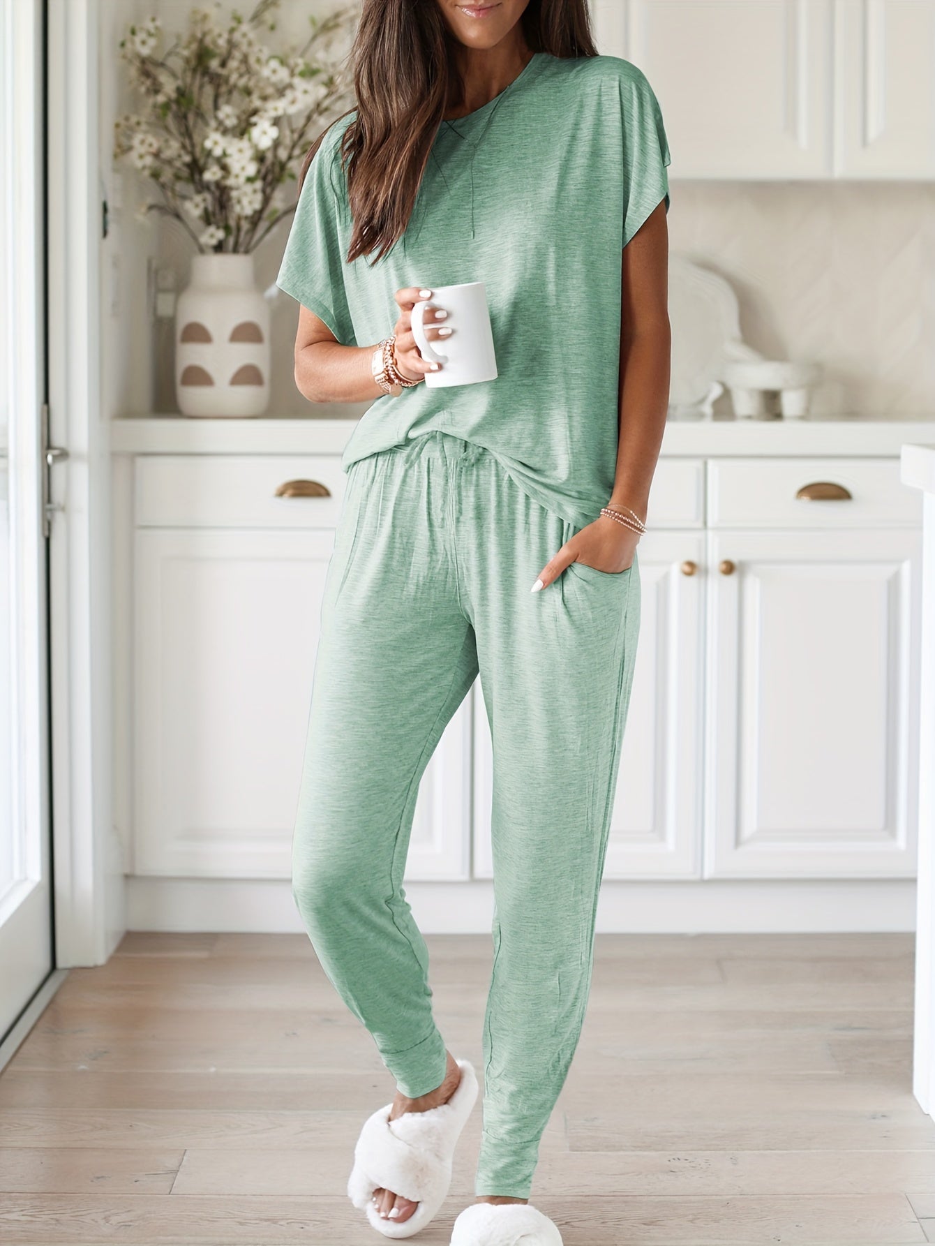 Light pink loungewear set for women includes a short sleeve top and long pants. Made from stretchy, machine washable polyester blend with pockets - perfect for all seasons.