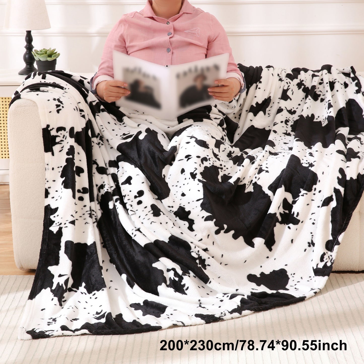 Get cozy with this soft and warm cow print blanket. Perfect for adding a touch of whimsy to your sofa, couch, or bed, this lightweight throw is made from plush flannel fleece. It's a great gift idea for any cow lover and perfect for all seasons.