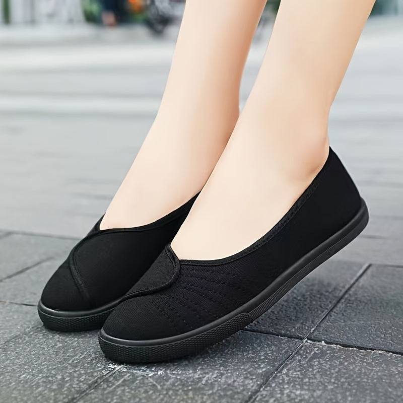 Women's white slip-on sneakers with breathable fabric upper, rubber sole, round toe, and sporty design.