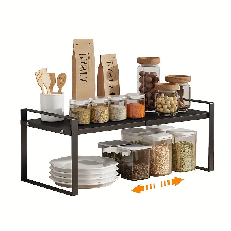 The 2-Tier Expandable Black Metal Cabinet Organizer Riser is a heavy-duty, non-slip storage shelf designed for use in the kitchen pantry, under sink, or on countertops. This stackable organizer is space-saving and features an open storage design, making