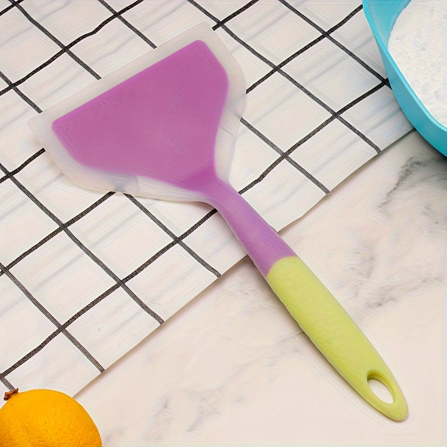 Nonstick silicone spatula turner for pancakes, eggs, fish, pizza, and steak. Heat-resistant and wide for easy flipping. Kitchen utensil accessory.