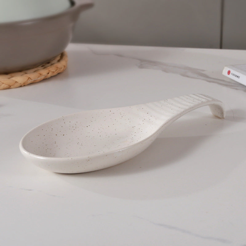 A single piece Ceramic Spoon Rest, beautifully handcrafted Soup Ladle Holder, featuring a Modern Country Style design. Perfect for organizing kitchen utensils, this European Vintage Creative Reaction Glaze piece comes with a practical Ladle Stand for