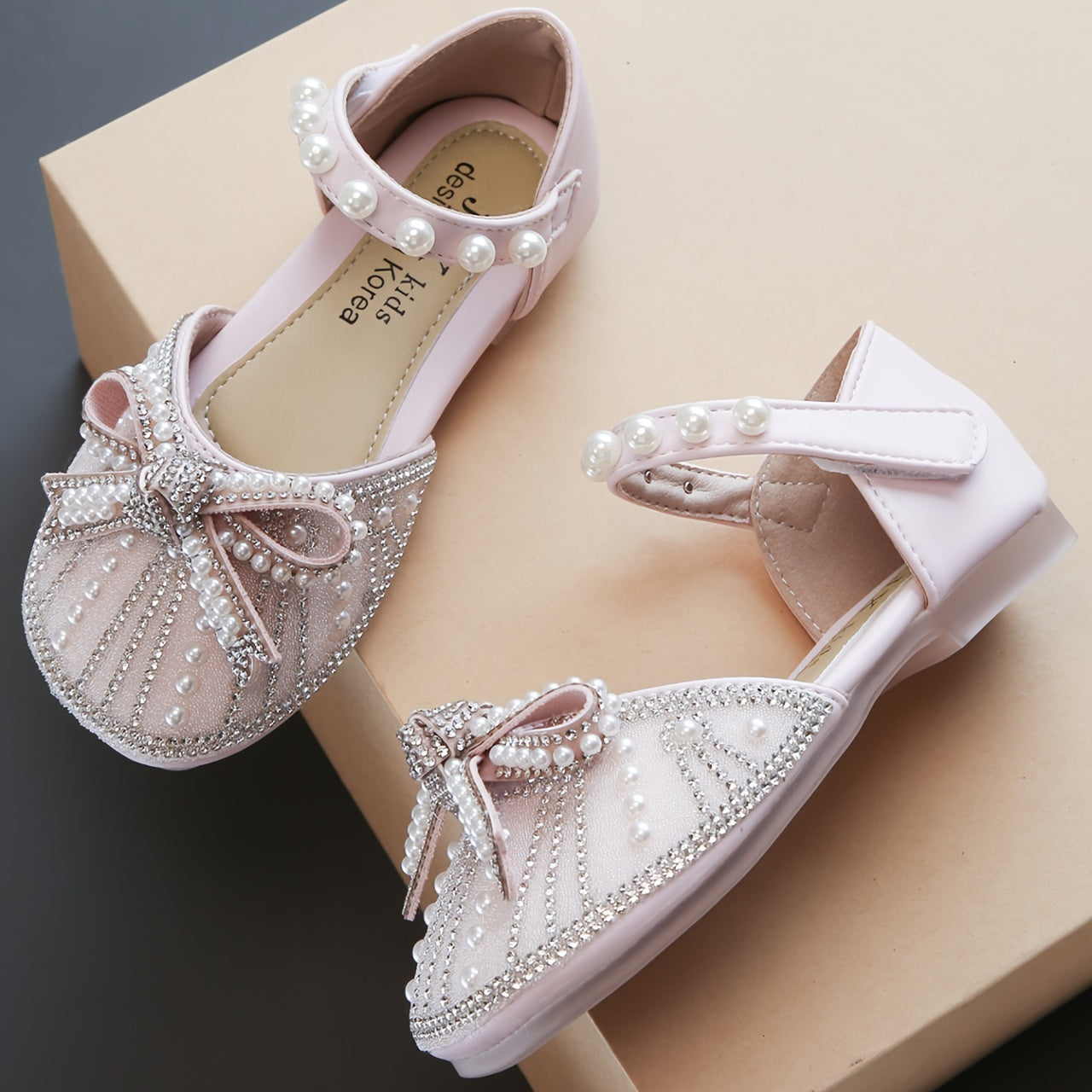 Sparkly bowknot flats with adjustable strap, durable TPR sole, comfortable for daily wear for girls aged 14 and under.