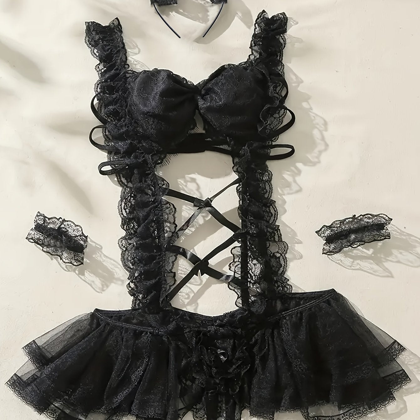 Sexy maid costume with mesh tights, suspender skirt, headwear, and bracelet.