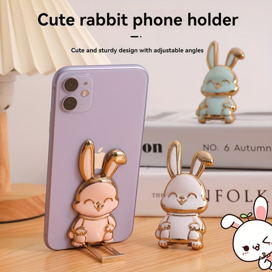 Foldable waterproof phone stand made of ABS material, featuring an adjustable cartoon bunny design for holding smartphones and tablets.