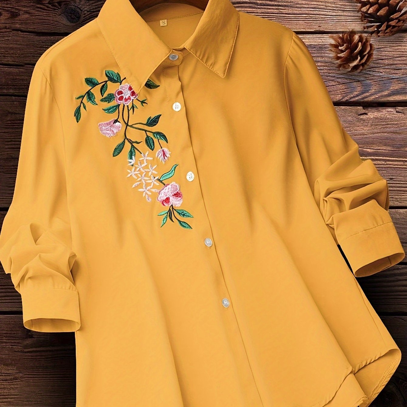 Embroidered floral button-up shirt for women, perfect for spring and fall.