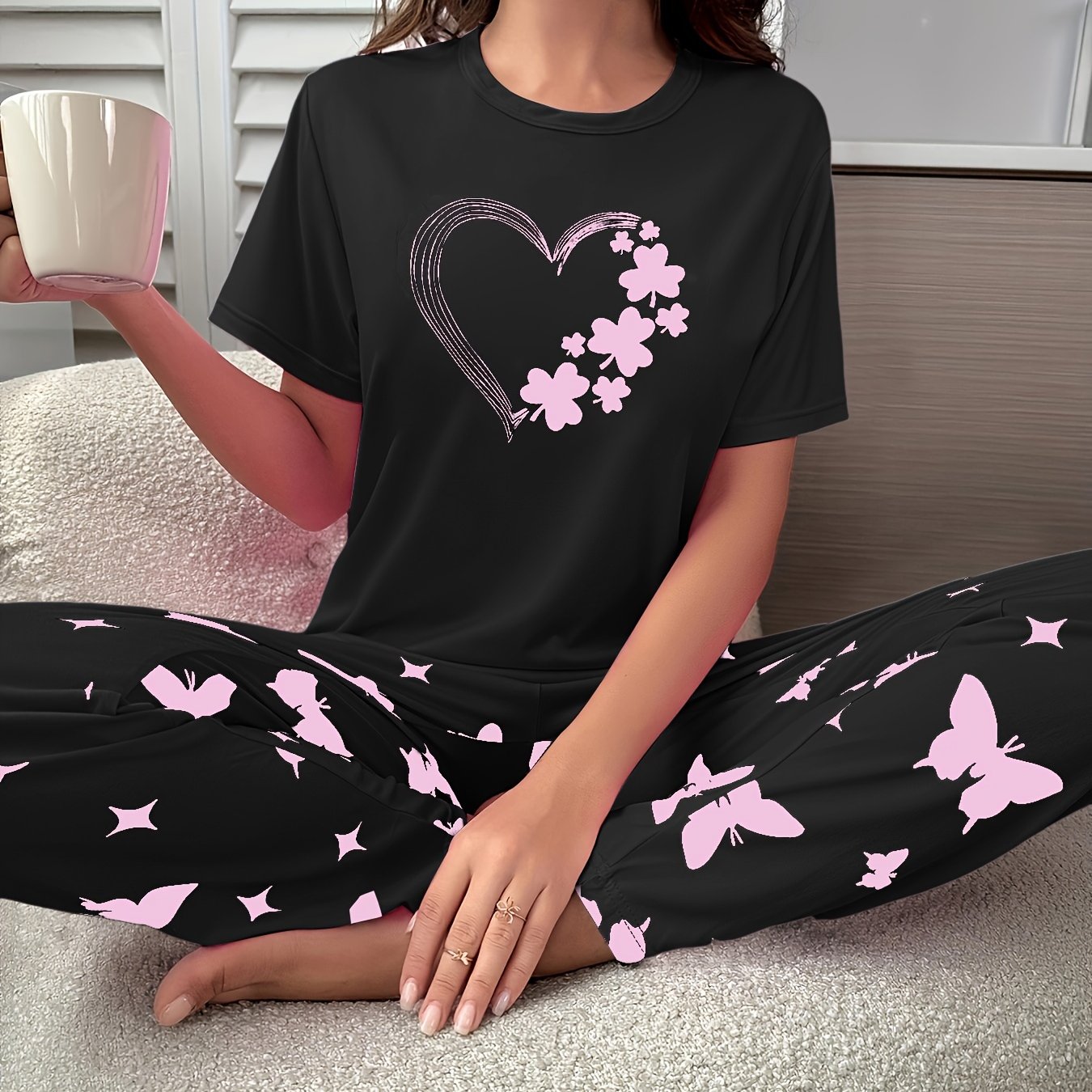 Short-sleeve top and shorts set with hearts, butterflies, and four-leaf clovers pattern, for sleepwear and loungewear.