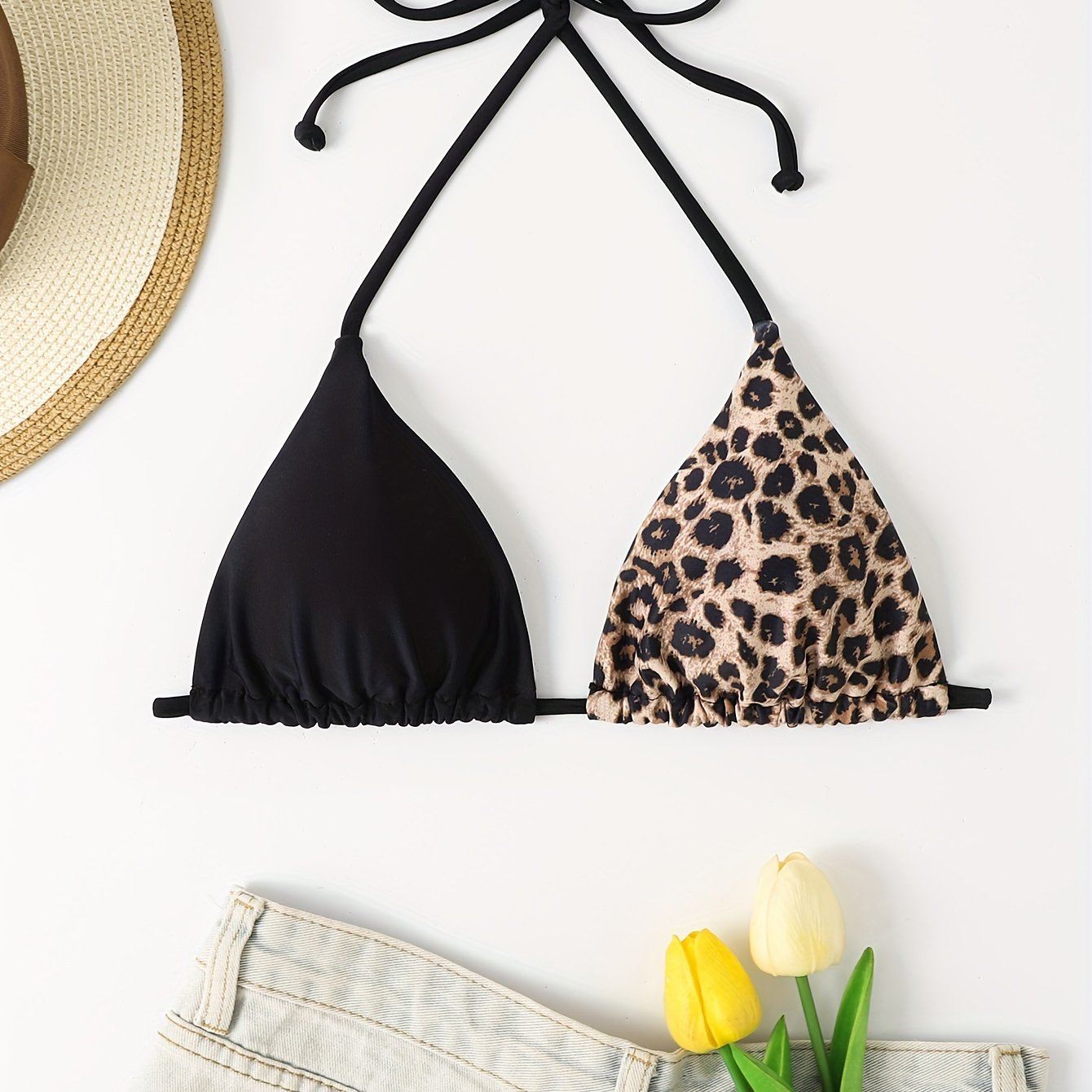 Two-tone triangle bikini top with leopard print and solid black color, adjustable tie back for poolside or beach fashion.