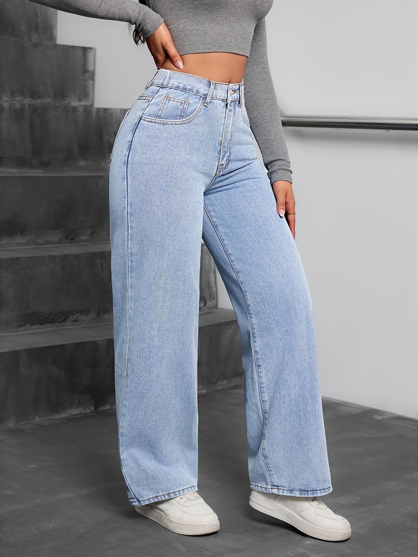 Simple washed blue denim pants for women, casual and basic style.