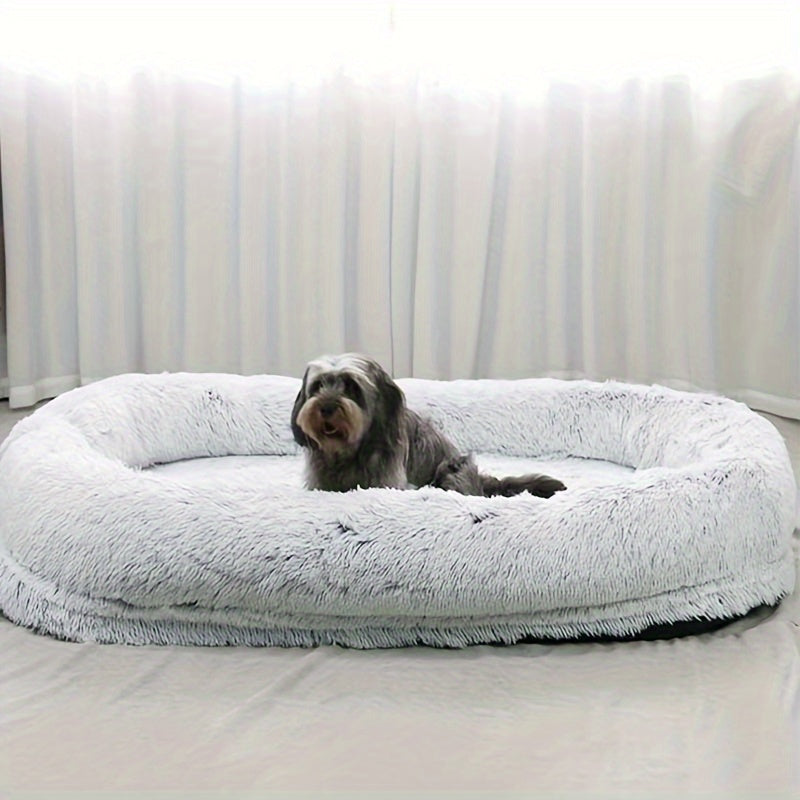 Oval-shaped plush sofa bed for dogs and people, cozy and warm with a non-slip bottom and machine washable in gray color.