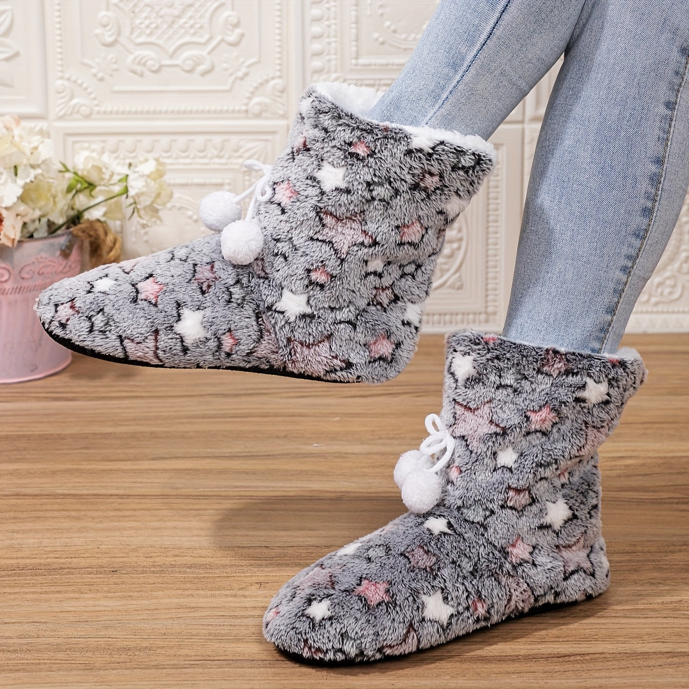 Heart-patterned slipper boots with cozy fleece lining, machine washable for indoor wear.