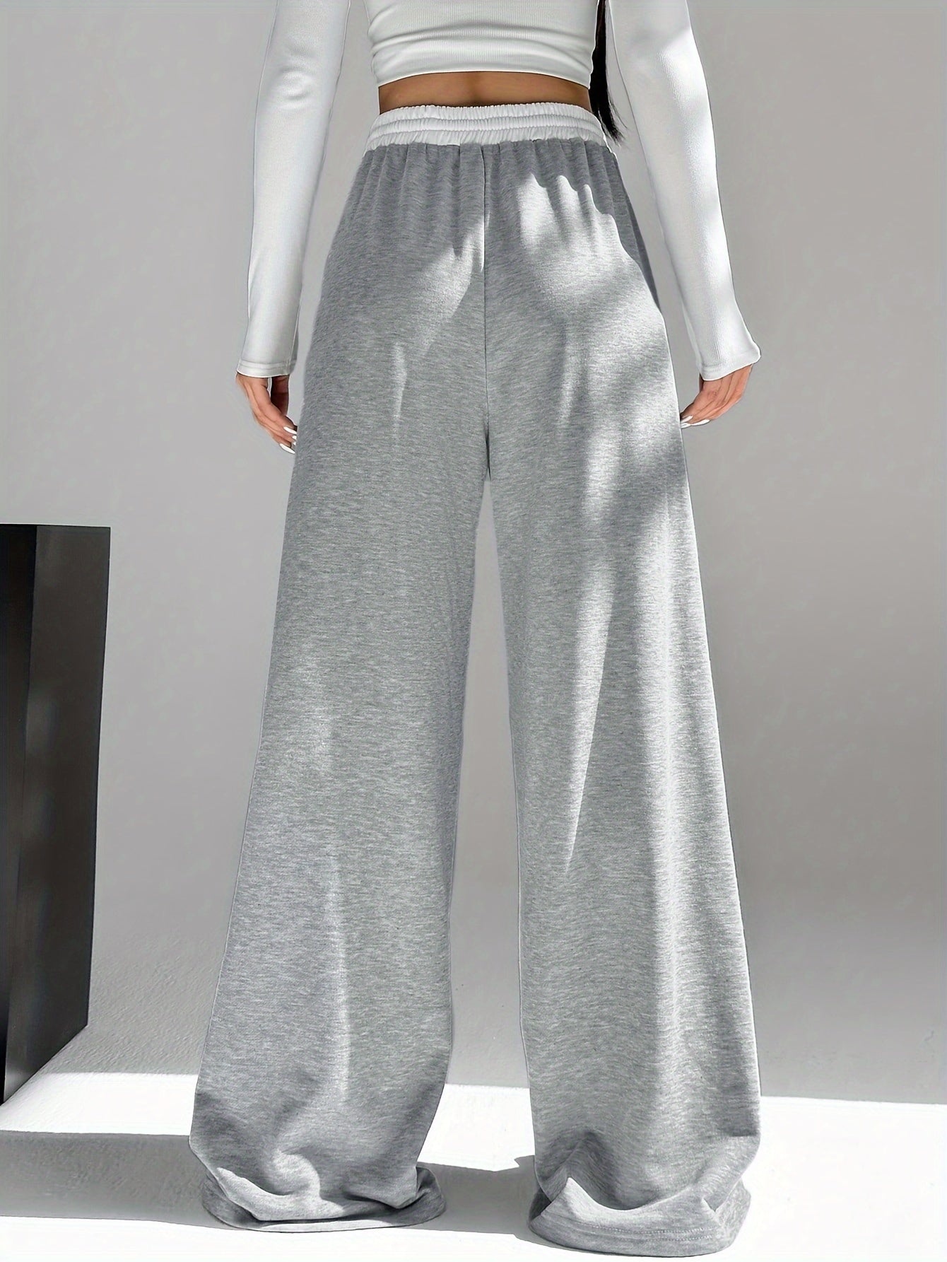 High waist wide leg drawstring pants in contrasting colors for women's spring and fall attire.