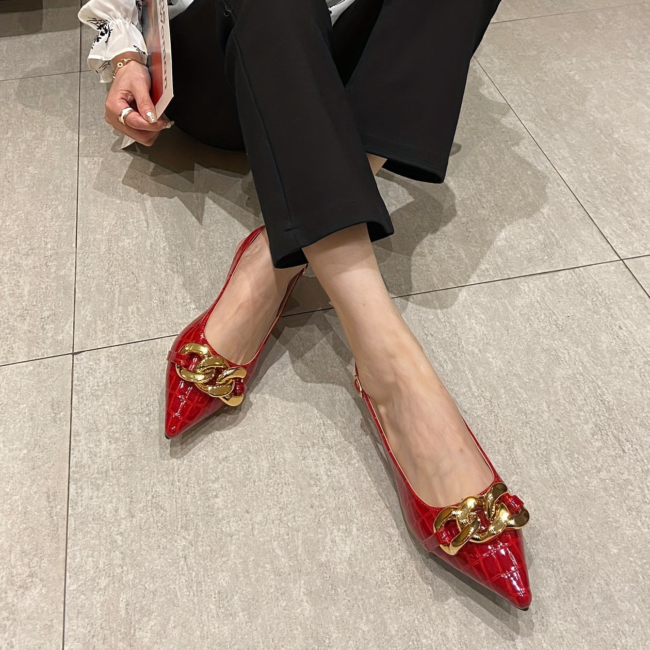 Stylish flat shoes with chain decor and buckle strap, featuring a point toe and slingback design for women.