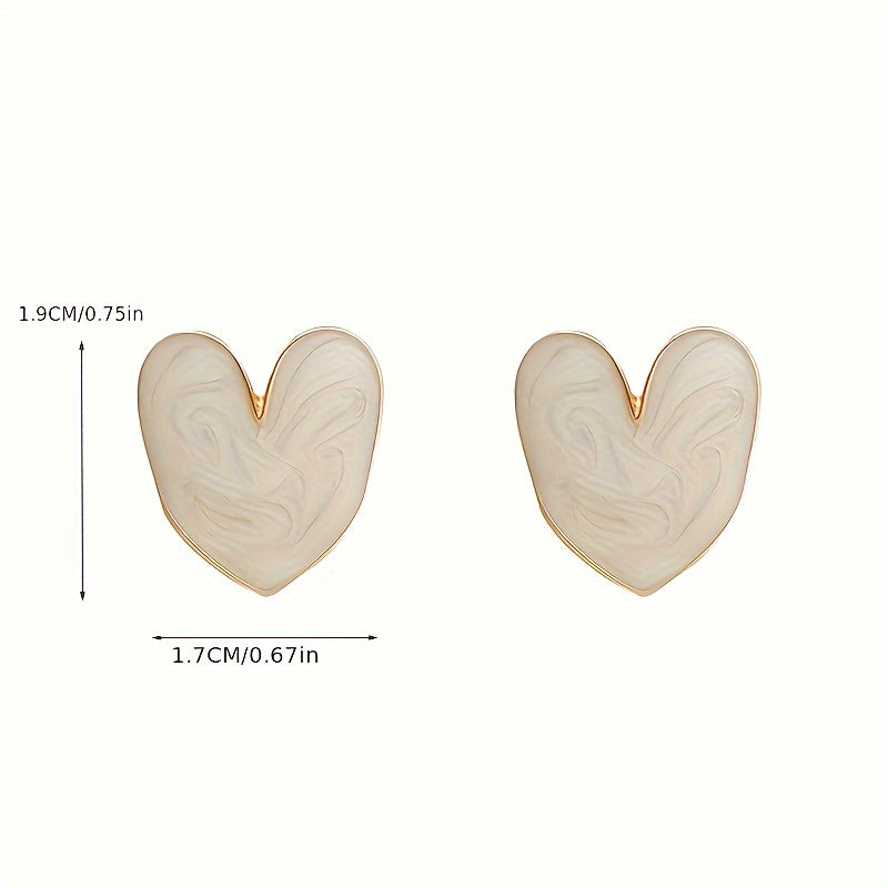 White enamel heart-shaped stud earrings with 925 sterling silver post for everyday and special occasions.