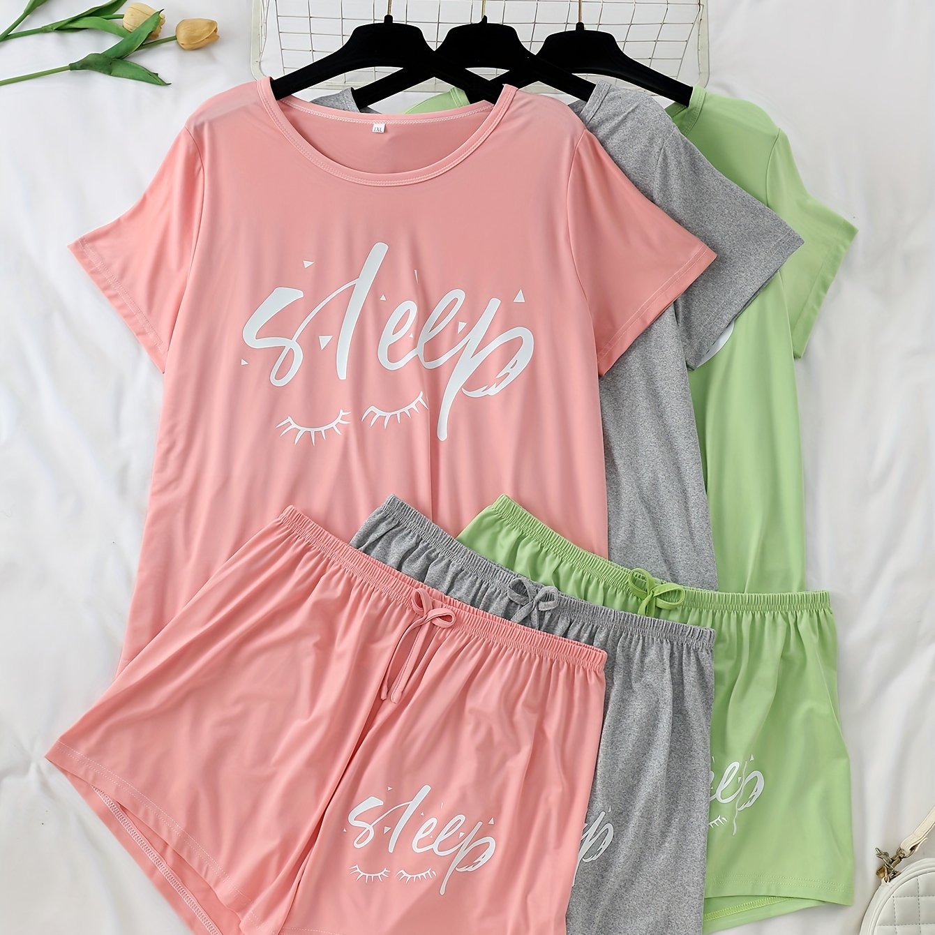 Women's 3-piece pajama set featuring alphabet print, polyester knit fabric with stretch, color block short sleeve top and shorts. Perfect for fall season lounging at home.