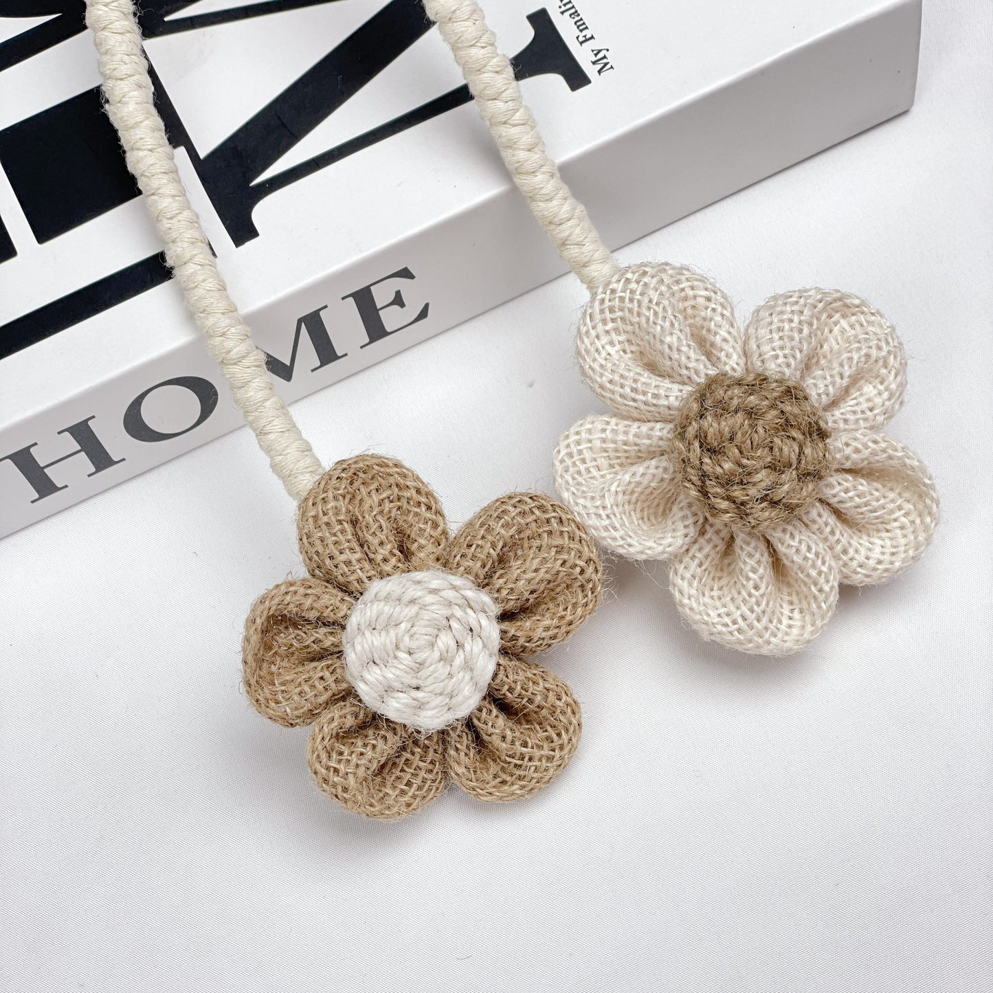 Multipack of handcrafted flower knot curtain tiebacks made from boho style cotton and linen - perfect decorative holdback clips for living room, bedroom, and home decor.