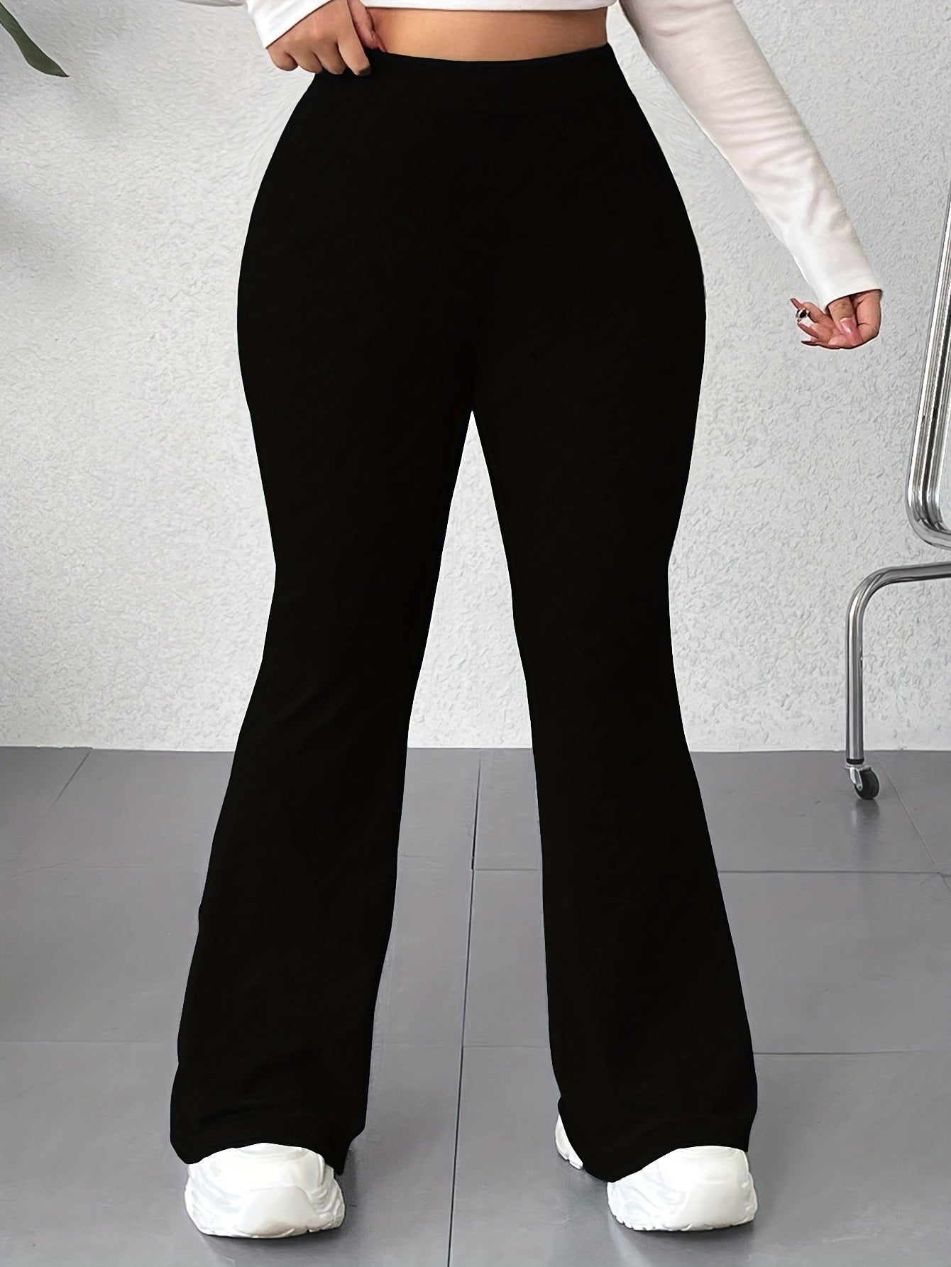 Solid color flared leg pants with a high waist, perfect for spring and summer in plus size women's clothing.