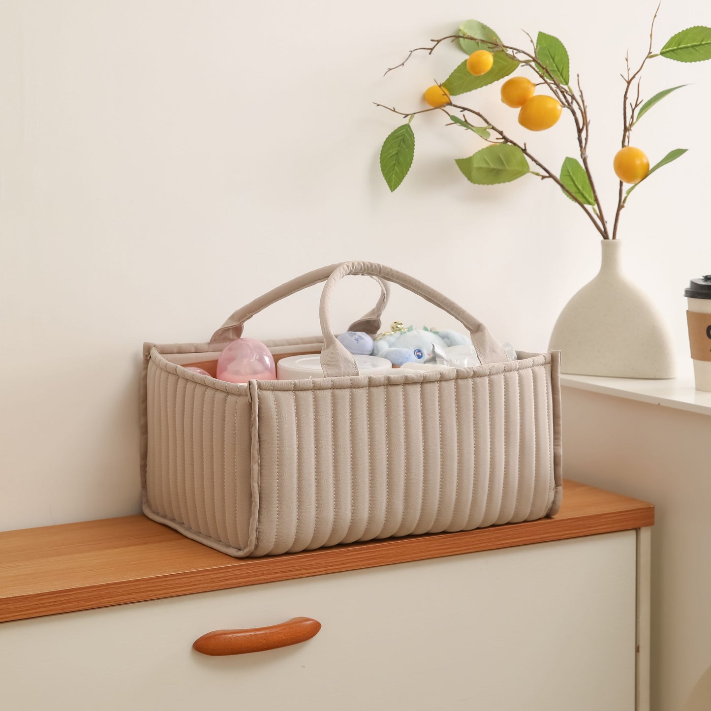 Portable nursery storage basket with handle made of polyamide, designed to organize diapers conveniently. This caddy is essential for keeping diapers, clothes, and toys in order. Perfect as a shower gift or registry item for new parents.