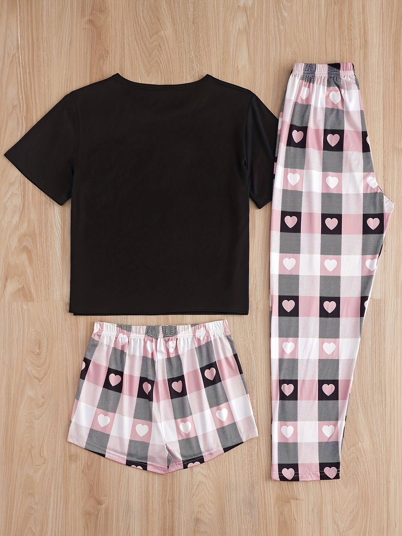 Women's casual pajama set with heart and plaid print, slogan, short sleeve top, and relaxed fit.