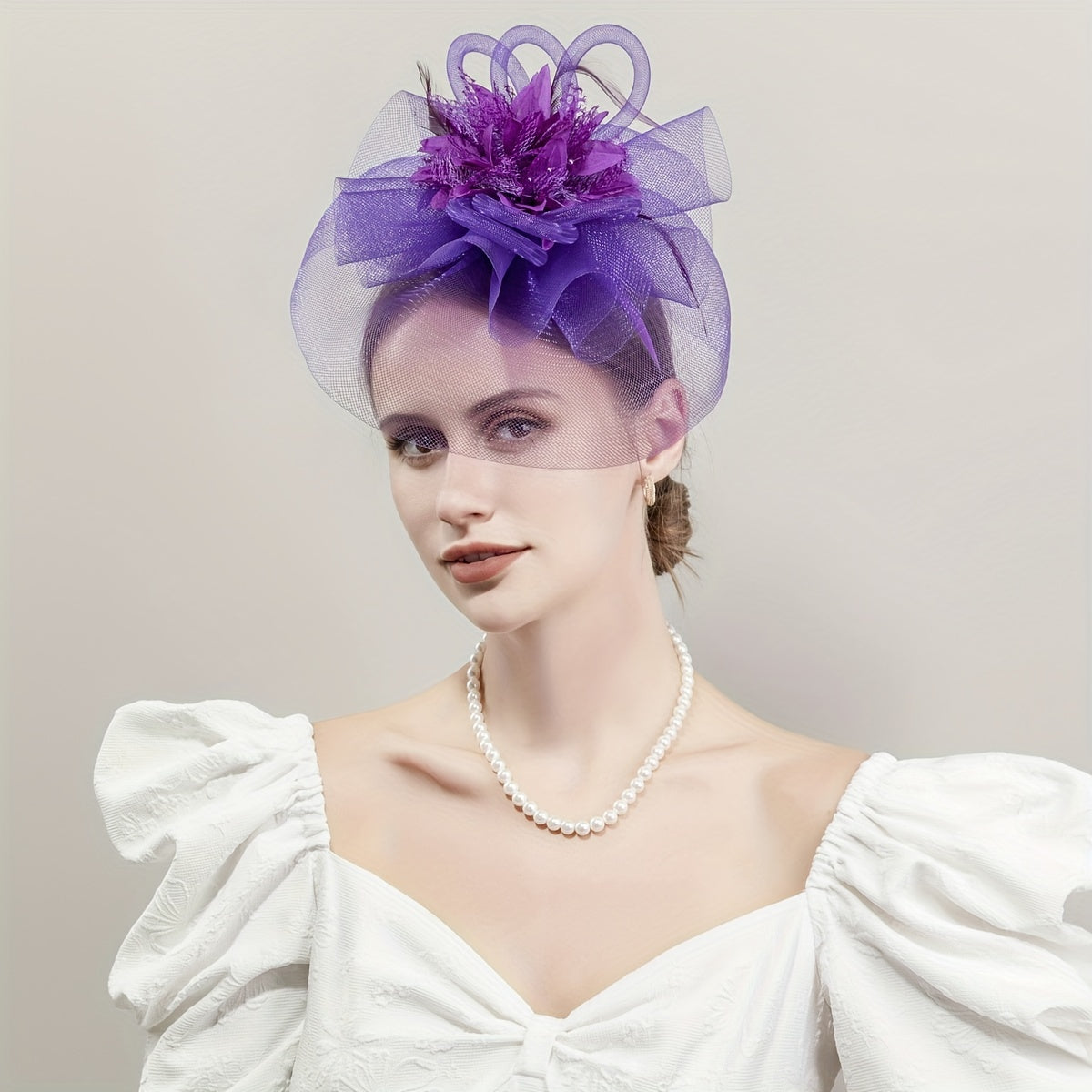 One piece of women's hair accessory featuring a mesh flower, faux feather detailing, and veil perfect for birthday parties, the Jockey Club, weddings, derby hats, and church events.