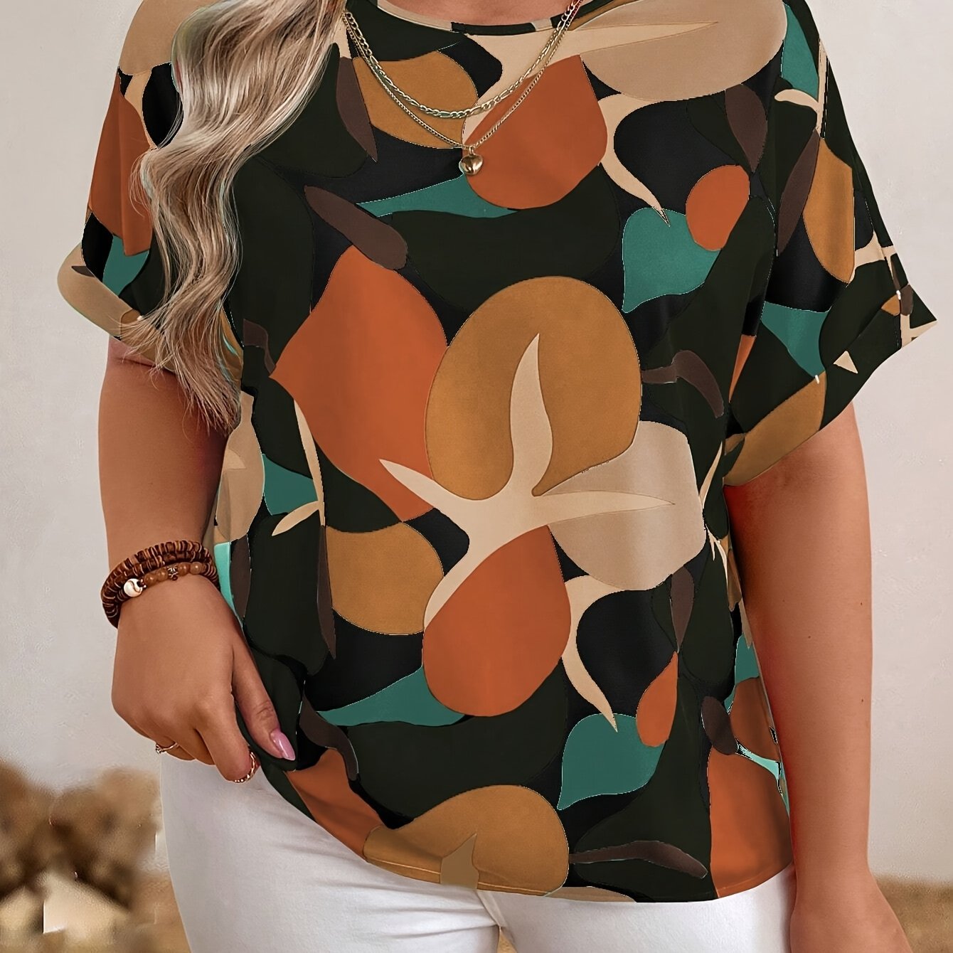 Plus size floral print batwing sleeve blouse in orange, brown & green camouflage design for women. Casual crew neck summer top.