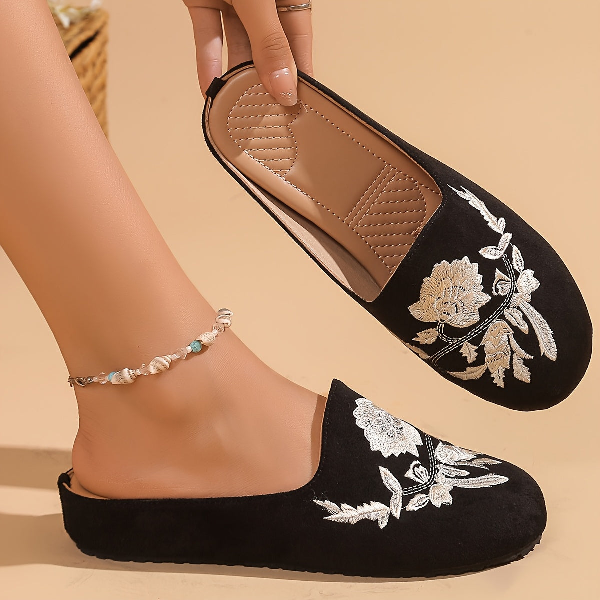 Stylish black embroidered floral mules with soft rubber sole and faux cover lining for comfortable year-round wear.